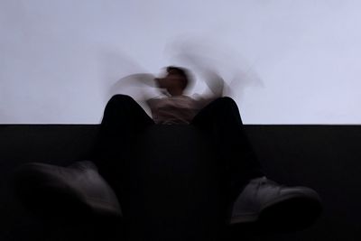 Young woman sitting on sofa at home