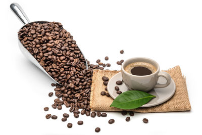 High angle view of coffee beans on white background