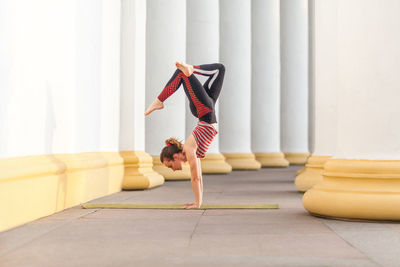 Low section of woman exercising on floor