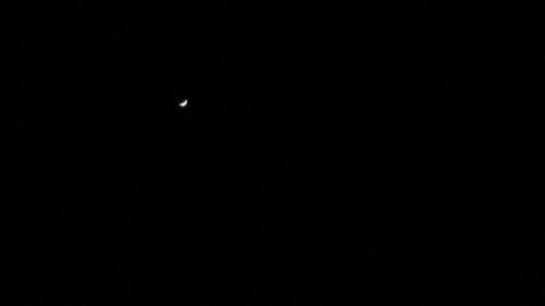 Low angle view of moon against sky at night