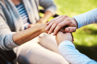 Midsection of couple holding hands