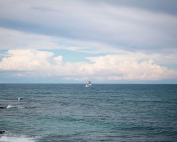 Sailboat in sea against sky