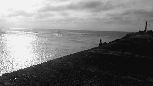 Scenic view of sea against cloudy sky