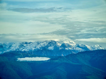 Scenic view of snowcapped mountains against sky
