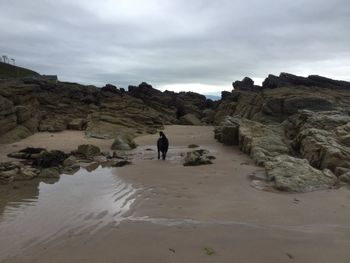 Rear view of tourists on rock