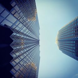 Low angle view of modern glass building against clear sky