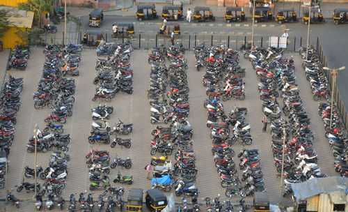 High angle view of vehicles at parking lot by road