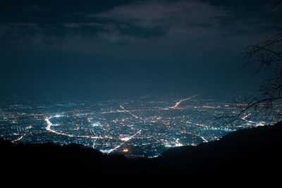 Aerial view of illuminated cityscape against sky at night