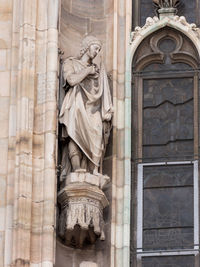 Statue in front of historic building