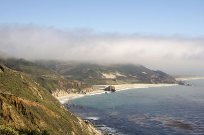 Scenic view of beach and mountains against sky