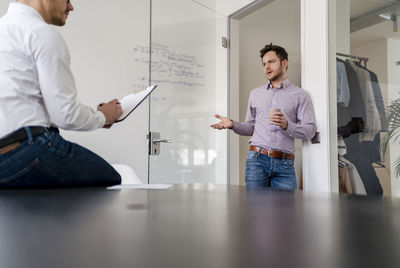 Businessman planning with male colleague during meeting in office