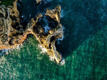 Aerial view of rock formation in sea