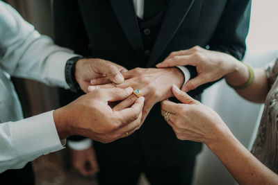 Pile of happy family hands putting rings