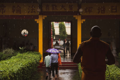 Rear view of people walking on a chinese monastery