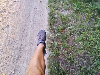 Low section of man over dirt road