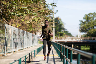 Full length of man standing on footbridge