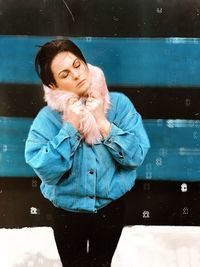 Woman looking away while standing outdoors