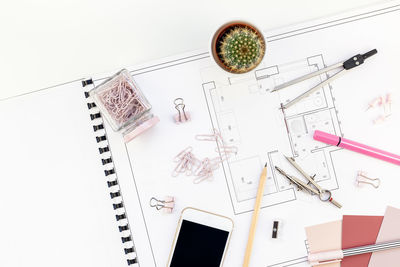 High angle view of pen and paper on table