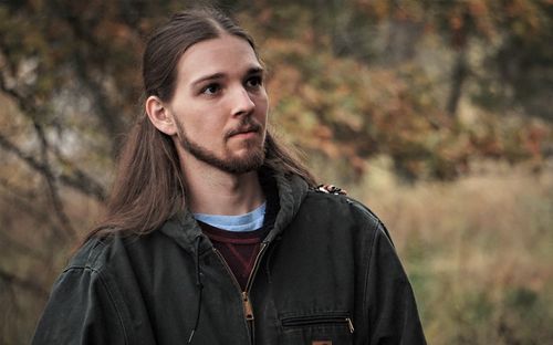 Portrait of young man standing outdoors