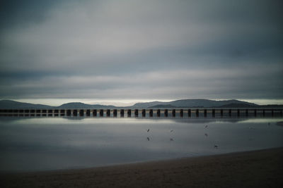 Bridge over sea against sky