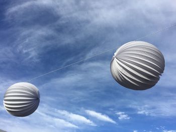 Low angle view of lighting equipment against blue sky