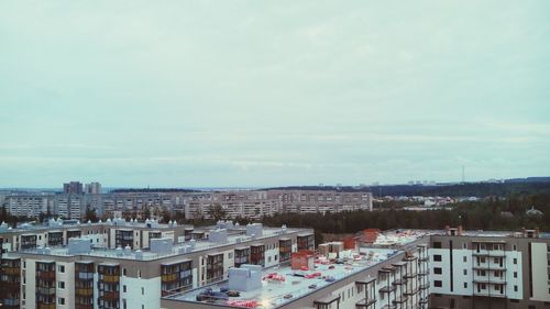 Buildings against cloudy sky