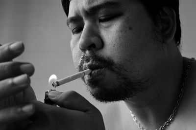 Close-up of man smoking cigarette