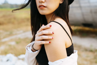 Side view of woman standing against blurred background