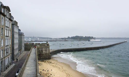 Scenic view of beach against sky in city