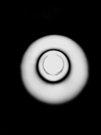 Close-up of spiral light over black background