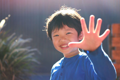 Portrait of smiling cute boy gesturing