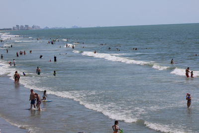 People on beach against sky