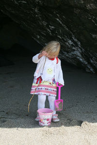 Girl standing against pink umbrella