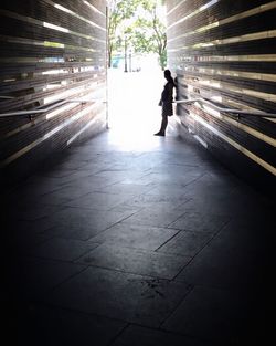 Silhouette of person walking in corridor