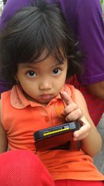 Portrait of cute girl using mobile phone