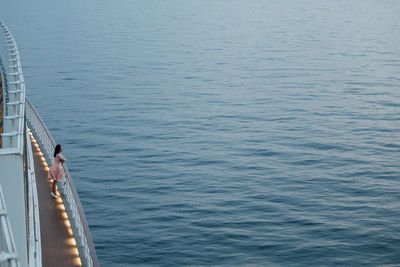 Woman standing in ship on sea