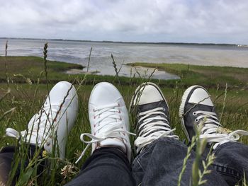 Low section of shoes on beach