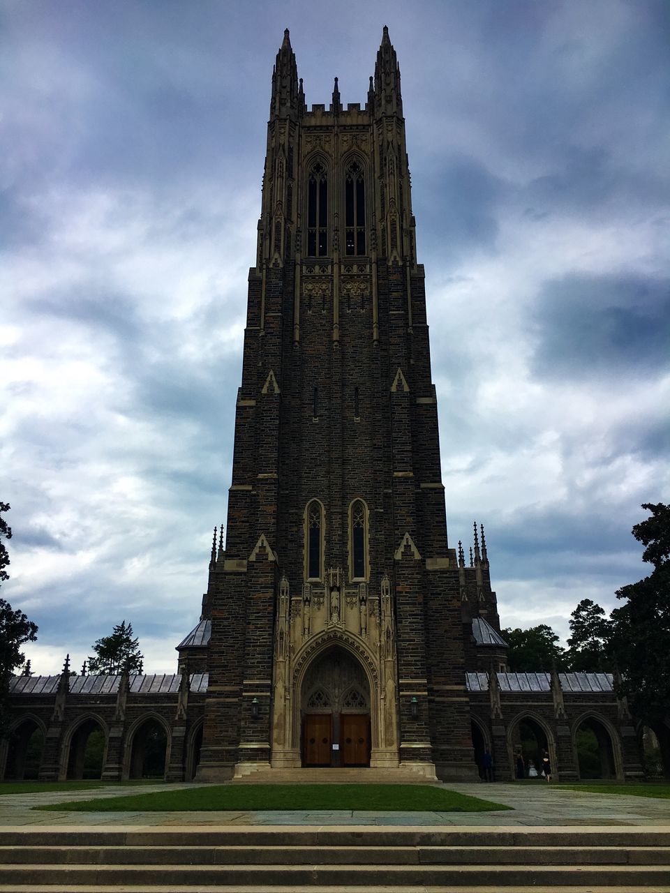 built structure, sky, architecture, building exterior, low angle view, outdoors, cloud - sky, no people, travel destinations, religion, place of worship, day, clock tower, grass, rose window