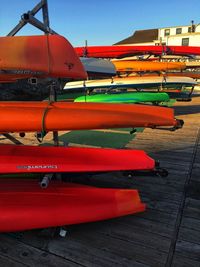 Multi colored boats moored on shore against sky