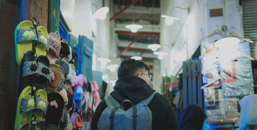 Rear view of woman standing at market