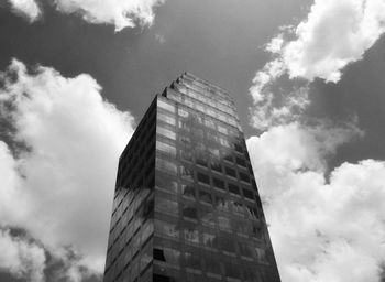 Low angle view of modern building against cloudy sky