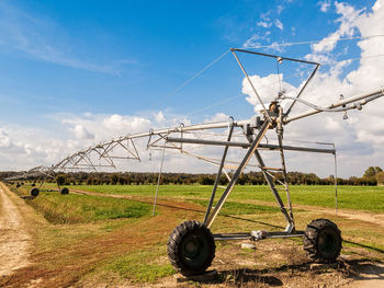 Traditional windmill on field against sky