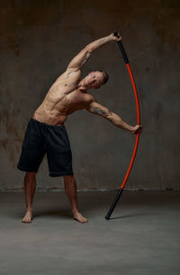 Athlete stretching against wall