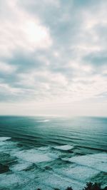 Scenic view of calm sea against cloudy sky