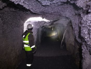 Rear view of man standing in tunnel