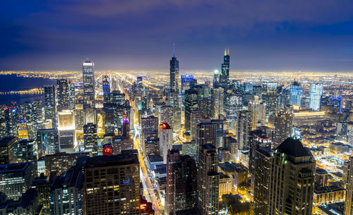 Aerial view of illuminated buildings in city