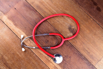 Directly above shot of red stethoscope on table