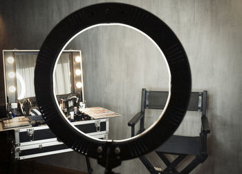 Reflection of illuminated electric lamp on table