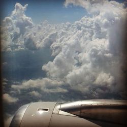 Airplane wing against sky