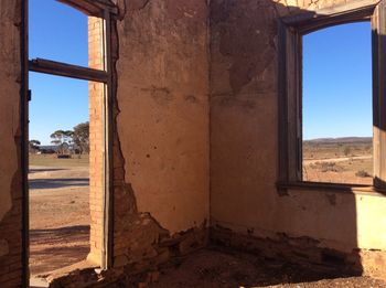 Abandoned building seen through window